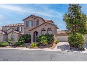 Charming two-story home with desert landscaping, a tile roof, and an attached two car garage at 10454 Gunpowder Falls St, Las Vegas, NV 89183