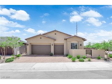 Charming single-story home featuring a three-car garage, desert landscaping, and a tile roof at 11909 Pippa Ave, Las Vegas, NV 89138