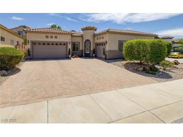Charming single-story home featuring a decorative front door and a spacious three-car garage at 1329 Calle Cantar, Henderson, NV 89012