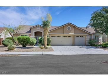 Charming single-story home featuring a three-car garage and well-manicured landscaping at 2262 Alanhurst Dr, Henderson, NV 89052