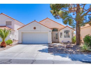 Charming single-story home with a well-maintained front yard and a two-car garage at 2752 Devita Cir, Las Vegas, NV 89117