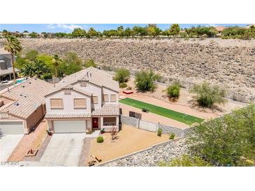 Two-story home featuring a two-car garage and a beautifully xeriscaped front yard with artificial turf at 3169 Crystal Moon Rd, Henderson, NV 89052