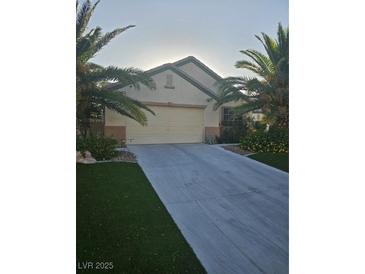 Well-maintained single-story home with palm trees and a spacious driveway at 5717 Blizzard Breeze St, North Las Vegas, NV 89081