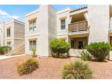 Attractive condominium complex with stucco exterior, balcony, and tidy landscaping at 6800 E Lake Mead Blvd # 1018, Las Vegas, NV 89156