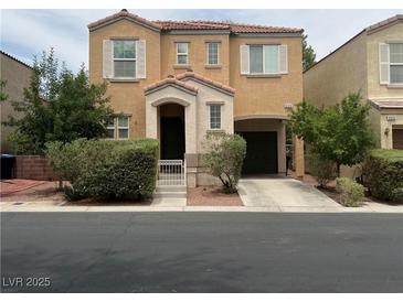 Charming two-story home featuring a quaint front porch and attached garage at 9100 Hombard Ave, Las Vegas, NV 89148