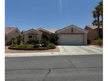 Charming single-story home with a two-car garage and lush desert landscaping at 10709 Heritage Hills Dr, Las Vegas, NV 89134