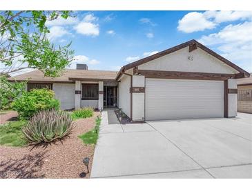 Charming single-story home with a well-maintained front yard and a two-car garage at 1105 Winwood St, Las Vegas, NV 89108
