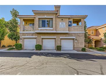 Three-story condo featuring garages and tan stucco finish at 251 S Green Valley Pkwy # 3222, Henderson, NV 89012