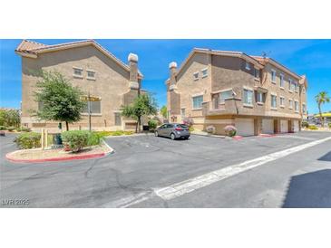Contemporary condo featuring neutral paint, garage parking, mature trees, and well-maintained landscaping at 2766 Red Vista Ct, Henderson, NV 89074