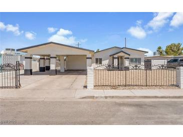 Charming single-story home featuring a carport, gated front yard, and desert landscaping at 2854 La Canada St, Las Vegas, NV 89169