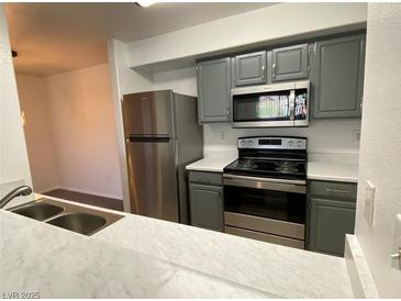 Well-lit kitchen featuring stainless steel appliances, gray cabinets, and white countertops at 555 E Silverado Ranch Blvd # 2030, Las Vegas, NV 89183