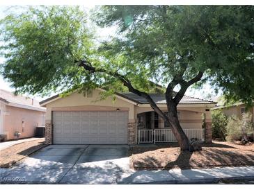 Charming single-story home featuring a two-car garage and low-maintenance desert landscaping in front at 7340 Alpine Ridge St, Las Vegas, NV 89131