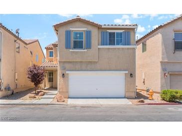 Two-story home with neutral stucco, matching shutters, a front yard, and a two car garage at 7553 Virginia Dale St, Las Vegas, NV 89131