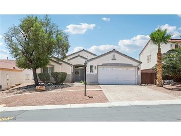 Charming single story home with a desert landscape and a two car garage and beautiful blue skies at 7927 Villa Salsa Ave, Las Vegas, NV 89131