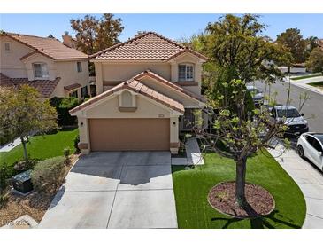 Charming two-story home featuring a well-manicured lawn and a two-car garage and concrete driveway at 9409 Kayla Ct, Las Vegas, NV 89134