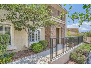 Charming home exterior featuring desert landscaping, decorative stone accents, and an inviting entrance at 10809 Garden Mist Dr # 1042, Las Vegas, NV 89135