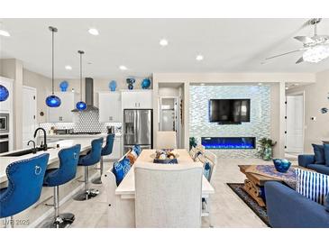 Bright, open-concept living space featuring a modern kitchen and stylish decor at 163 Caraset Ln, Henderson, NV 89011
