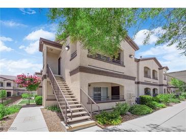 Exterior view of a condo featuring a staircase and landscaped yard under a sunny sky at 2291 W Horizon Ridge Pkwy # 6131, Henderson, NV 89052