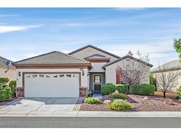 Charming single-story home featuring a well-maintained landscaped front yard and two-car garage at 2428 Hamonah Dr, Henderson, NV 89044