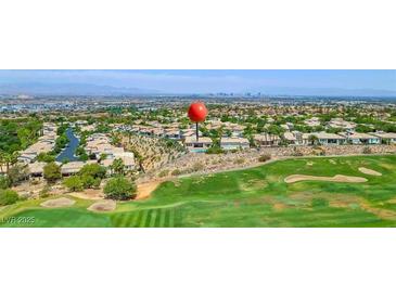 Expansive aerial view of luxury homes overlooking lush golf course with city skyline in the distance at 2997 Via Meridiana, Henderson, NV 89052