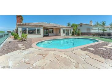 Inviting backyard pool with a stone surround, perfect for relaxation and entertaining at 2997 Via Meridiana, Henderson, NV 89052