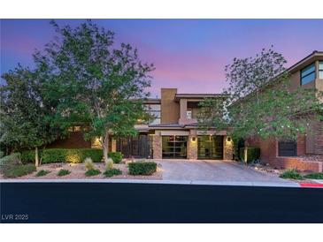 Stunning home exterior features a modern design, lush landscaping, and an inviting entrance at 38 Moonfire Dr, Las Vegas, NV 89135