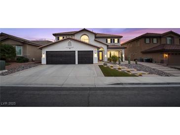 Charming two-story home with a two-car garage and desert landscaping for modern curb appeal at 387 Hoskins Ct, Henderson, NV 89012