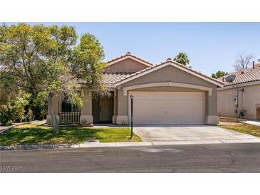 Charming single-story home featuring a two-car garage and well-maintained front yard at 4825 White Aspen Ave, Las Vegas, NV 89130