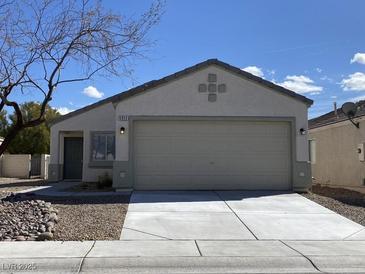 Charming single-story home with a well-maintained front yard and a two-car garage at 5912 Kentlands St, Las Vegas, NV 89130