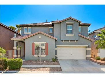 Charming two-story home featuring a gray facade, red tile roof, and well-maintained landscaping at 9021 Rendon St, Las Vegas, NV 89143