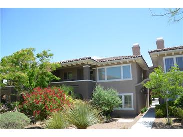 Beautiful two-story home featuring a red-tiled roof, well manicured landscaping, and lovely shrubs at 11830 Portina Dr # 2030, Las Vegas, NV 89138