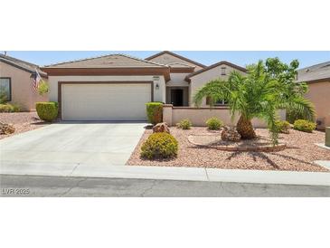 Charming single-story home with a two-car garage and meticulously landscaped front yard at 2555 Moonlight Valley Ave, Henderson, NV 89044