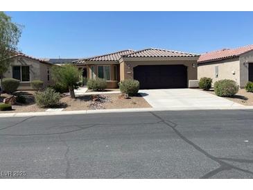 Charming single-story home with desert landscaping, a driveway and a two-car garage at 3712 Garnet Heights Ave, North Las Vegas, NV 89081