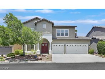 Charming two-story home with a well-manicured front yard and a two-car garage at 10673 Bonchester Hill St, Las Vegas, NV 89141