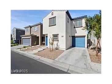 Two-story home with a two car garage and a blue entry and garage door at 1891 Via Del Prado St, Las Vegas, NV 89115