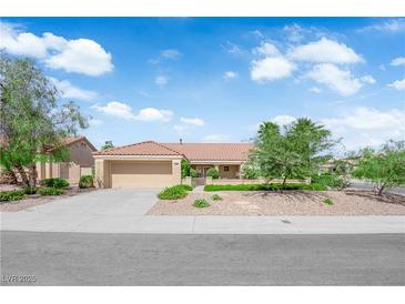 Charming single-story home boasts a terra cotta roof, desert landscaping, and an attached two-car garage at 2825 Brianwood Ct, Las Vegas, NV 89134