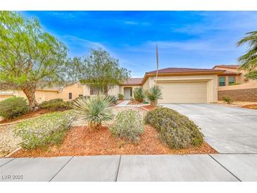 Charming single-story home with desert landscaping, a two-car garage and a long driveway at 3050 Canal Walk Rd, Henderson, NV 89052