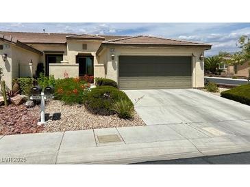 Inviting single-story home featuring a well-manicured yard and an attached two-car garage at 5147 Progresso St, Las Vegas, NV 89135