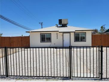 Charming single-story home featuring a black fence, gravel yard, and updated exterior at 532 N 9Th St, Las Vegas, NV 89101