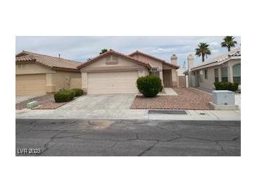 Charming single-story home with a desert-landscaped front yard, concrete driveway, and an attached two-car garage at 5824 Red Gull St, Las Vegas, NV 89149