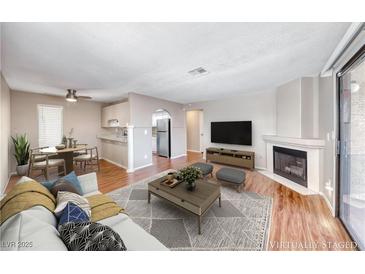 Bright living room featuring fireplace, wood floors, and neutral color scheme, perfect for relaxing and entertaining at 601 Cabrillo Cir # 536, Henderson, NV 89015