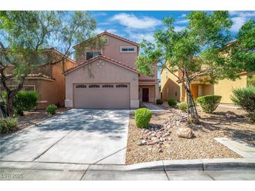 Charming two-story home featuring a two-car garage and a well-maintained landscaped front yard at 9031 Jumping Jacks Ave, Las Vegas, NV 89178