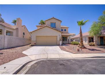 Two-story home featuring desert landscaping, attached garage, and concrete driveway at 9451 Natoma Station Pl, Las Vegas, NV 89123