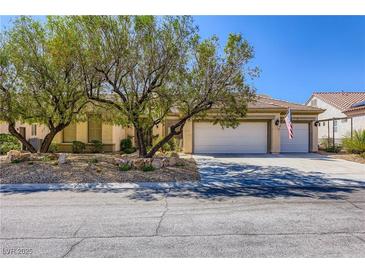 Charming single-story home with a three-car garage and mature trees in a well-maintained front yard at 1637 Wellington Springs Ave, Henderson, NV 89052