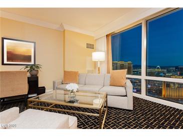 Bright living room featuring comfortable seating and a stunning cityscape view through large windows at 2000 Fashion Show Dr # 5300, Las Vegas, NV 89109