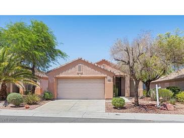 Charming single-story home featuring a well-maintained yard, mature trees, and an attached two-car garage at 2154 Eagle Sticks Dr, Henderson, NV 89012