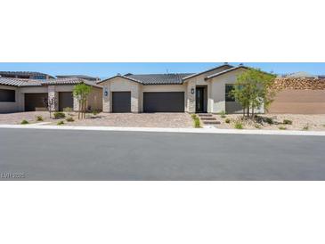 Charming single-story home featuring a three-car garage and desert landscaping at 364 Tigullio Ave, Henderson, NV 89011