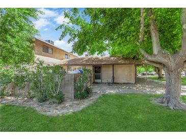 Charming single story home featuring a well-maintained lawn and mature trees at 5083 Village Dr, Las Vegas, NV 89142