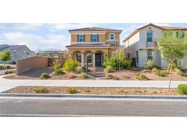 Charming two-story home featuring a covered front porch and well-maintained desert landscaping at 1102 E Dorrell Ln, North Las Vegas, NV 89086