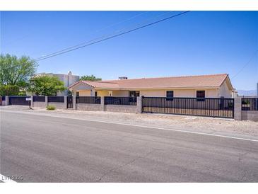 Charming single-story home featuring desert landscaping, a secure fence, and a tile roof at 2935 Hardin Dr, Henderson, NV 89074